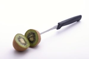 Sliced kiwi knifed at its core